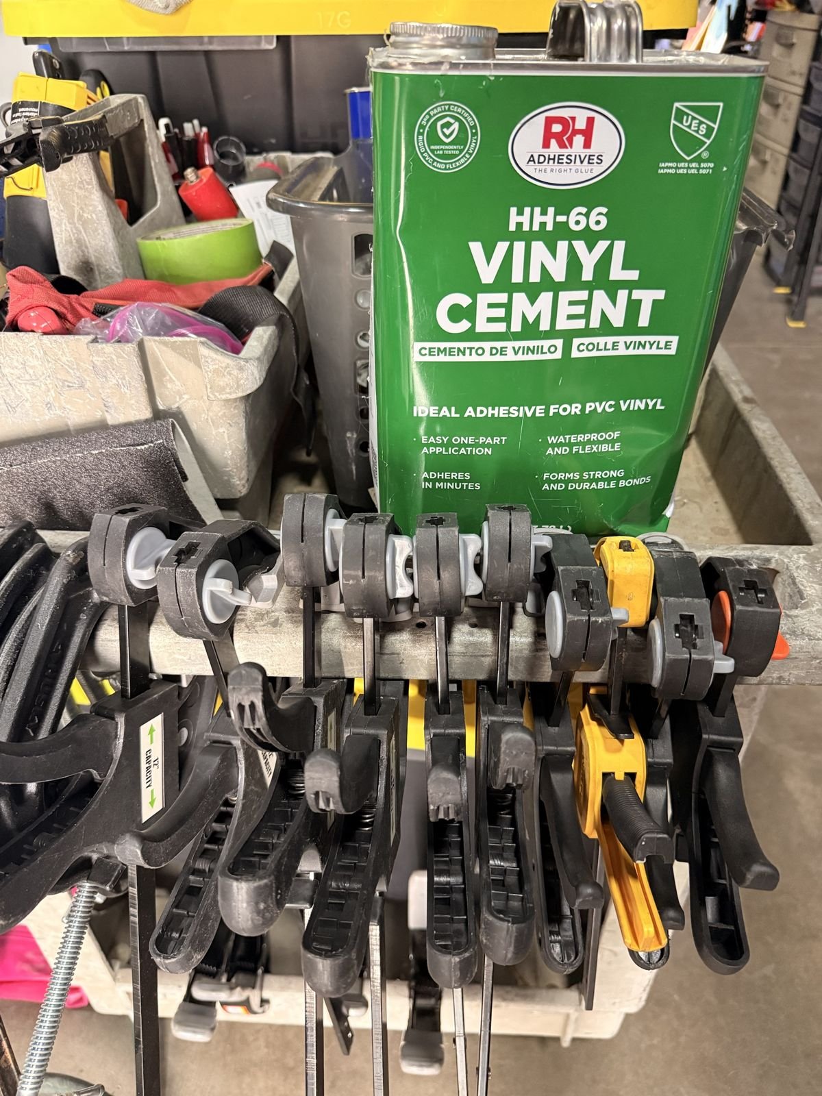 Can of HH-66 vinyl cement on the Redline repair cart with a row of clamps