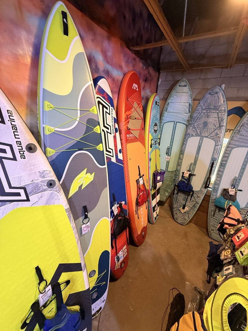 A wall of Aqua Marina paddleboards